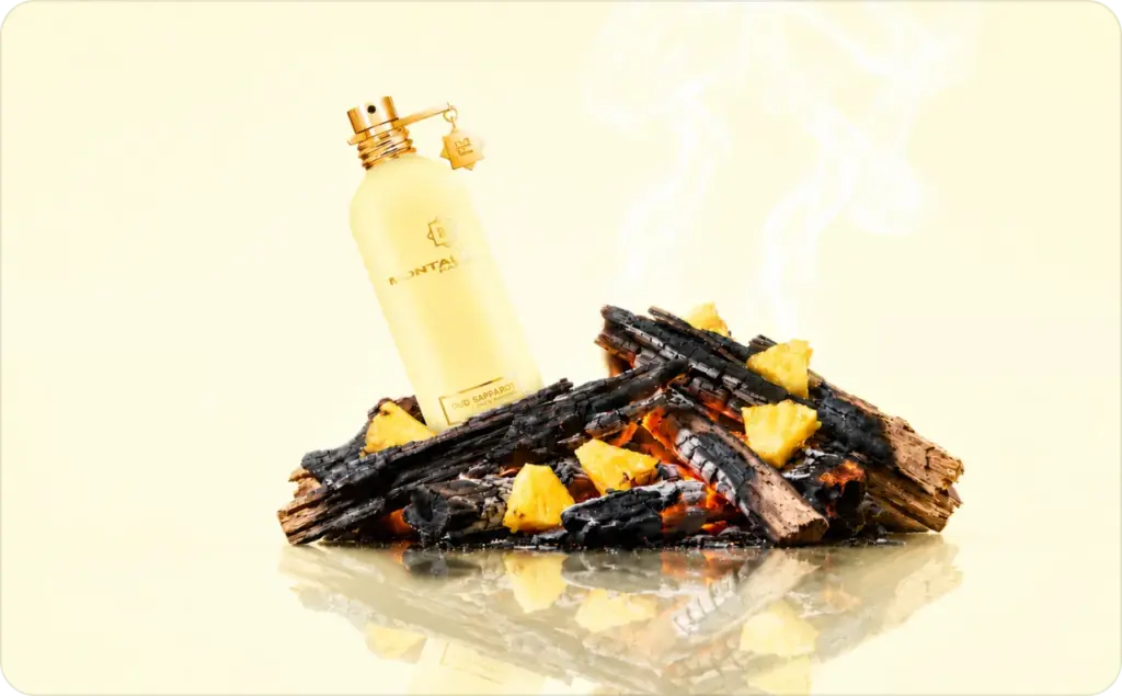 Ad creative tips: luxury Oud Sapparot perfume bottle displayed above smoldering oud wood and fresh pineapple chunks on a light lemon background, highlighting the contrast between smoky woody notes and vibrant tropical sweetness in a premium fragrance advertisement.