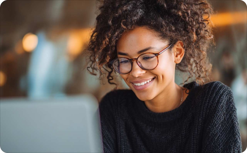 The woman in glasses looking at the laptop screen