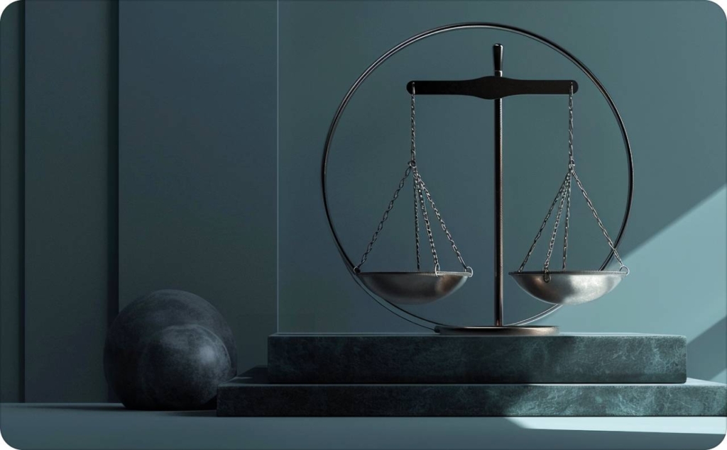 A modern minimalist image of balanced metal scales of justice on a marble base, symbolizing law and fairness, lit by soft natural light in a contemporary setting.