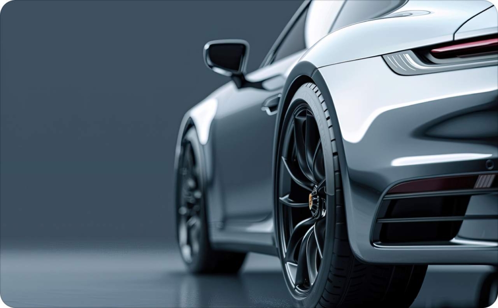 Close-up rear view of a sleek silver sports car used in best car ads, showcasing glossy bodywork and black alloy wheels.