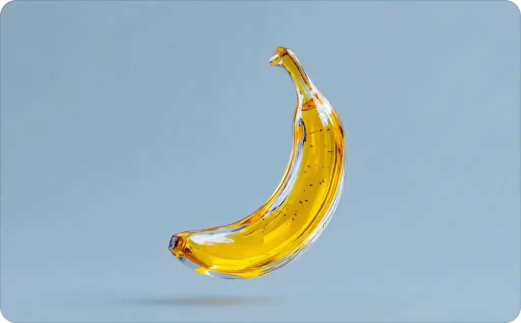 Nano Banana vs Nano Banana Pro comparison image featuring a glossy, transparent glass banana sculpture with a vibrant yellow interior, floating against a soft blue gradient background. The minimalist 3D render highlights a sleek, premium aesthetic with realistic reflections and subtle shadows.